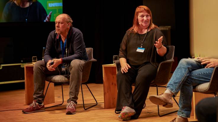 Auf der Bühne sitzen Vladimir Slivyak und Kerstin Rudek.